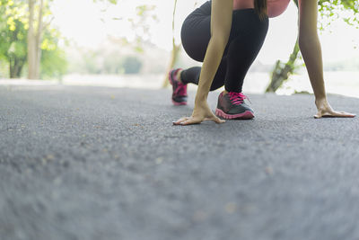 Low section of woman on road