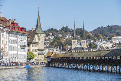 River amidst buildings against sky in city