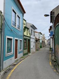 Empty road amidst buildings in town