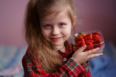 Girl with a box of strawberries