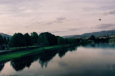 Scenic view of lake against sky at sunset