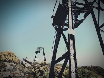 Low angle view of crane against clear sky