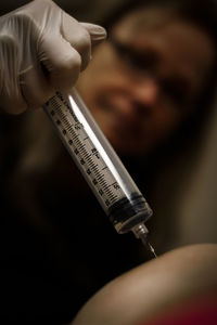 Close-up of doctor injecting patient