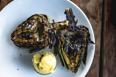 Close-up of roasted artichoke hearts on plate