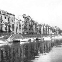 Boats in river with buildings in background