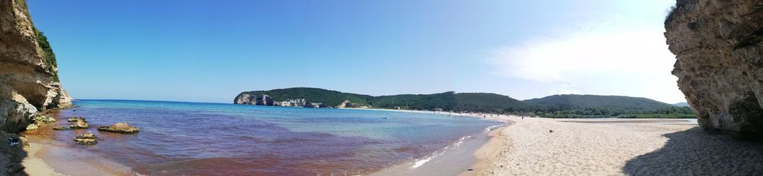 Panoramic view of beach against blue sky