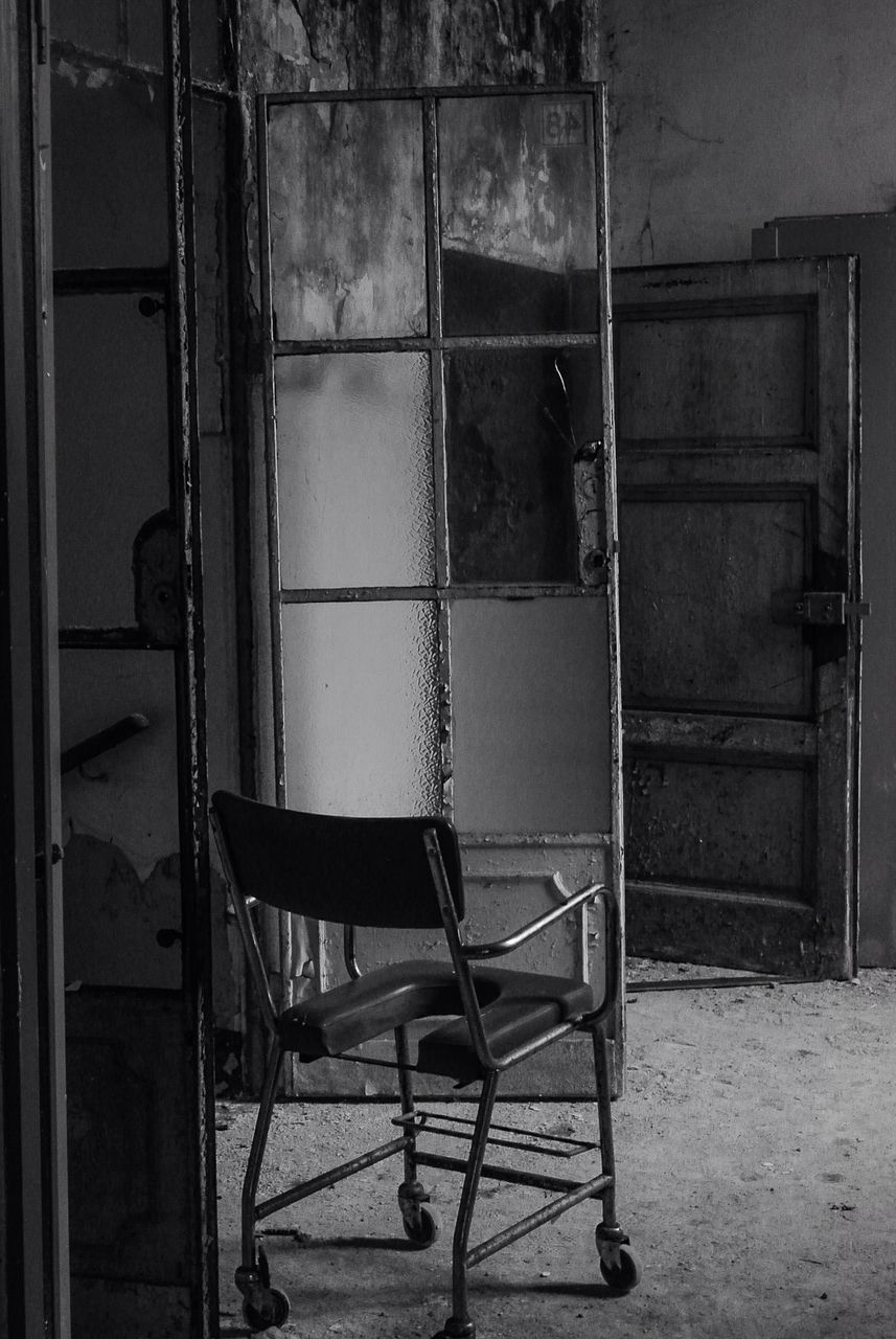 indoors, chair, absence, empty, built structure, architecture, abandoned, wall - building feature, wall, old, door, seat, house, no people, window, building exterior, day, metal, furniture, interior