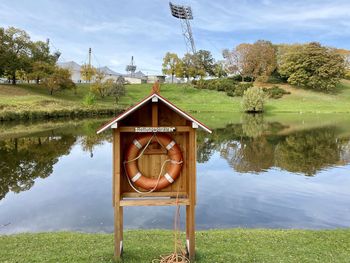 Built structure by lake against sky