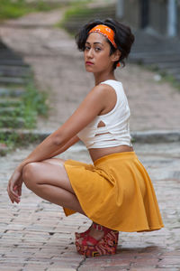 Portrait of young woman sitting outdoors