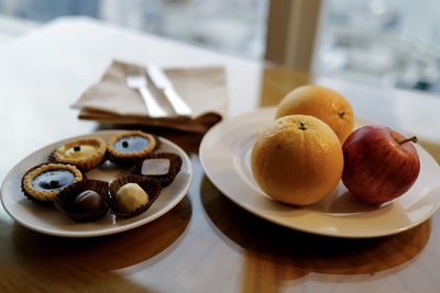 Close-up of fruits and dessert on table