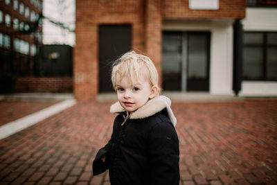 Blonde toddler in historic fells point baltimore, in the winter