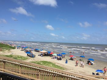 People on beach against sky