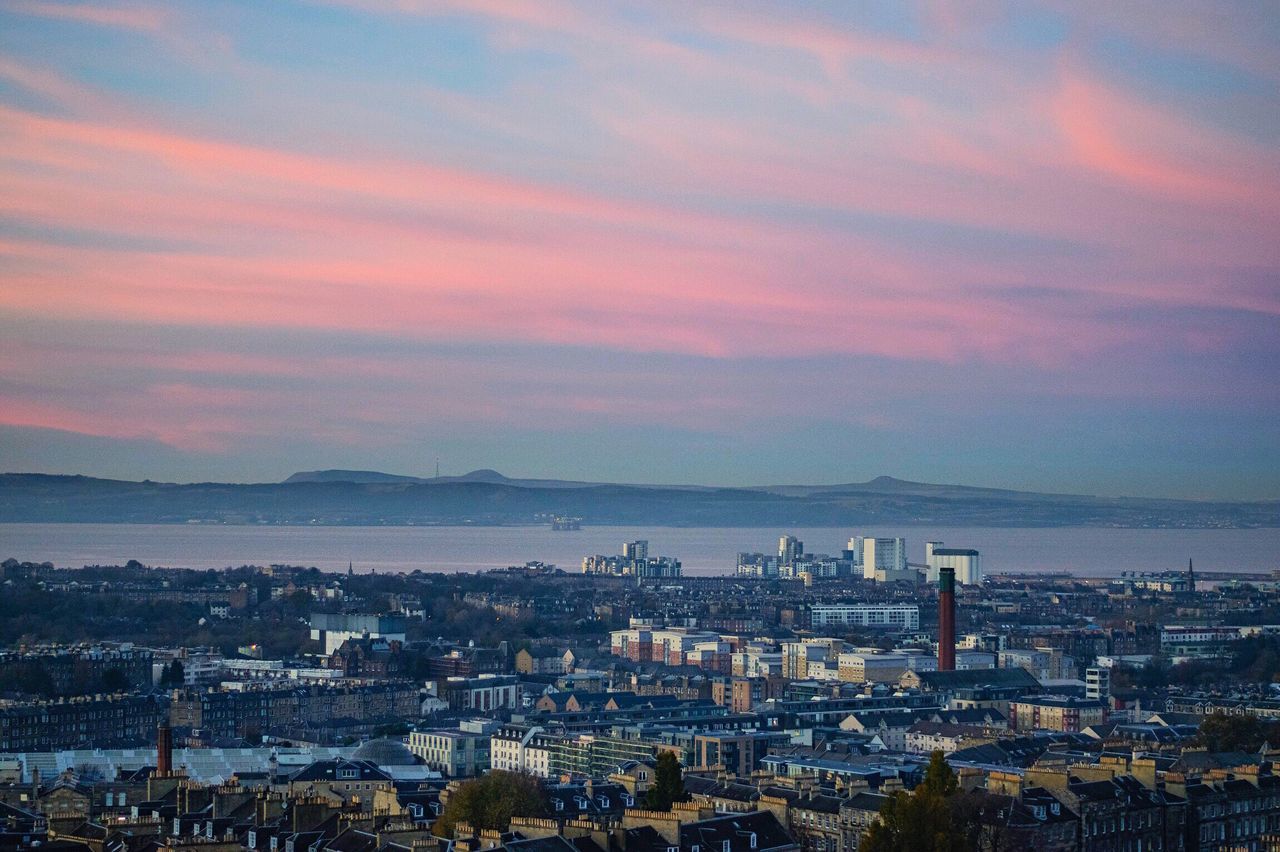 VIEW OF CITYSCAPE AGAINST SKY DURING SUNSET