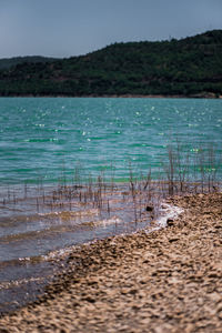Scenic view of lake against clear blue sky