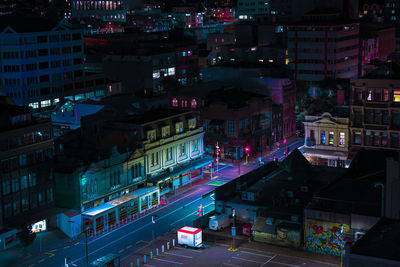 High angle view of illuminated street amidst buildings in city