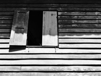 Close-up of weathered window on wooden wall