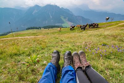 Low section of people relaxing on field