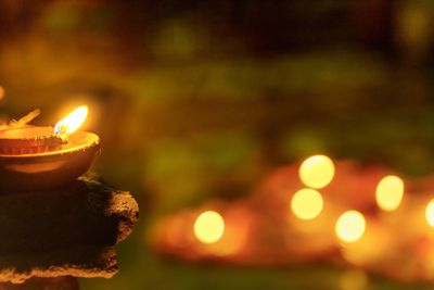Close-up of lit candles against blurred background
