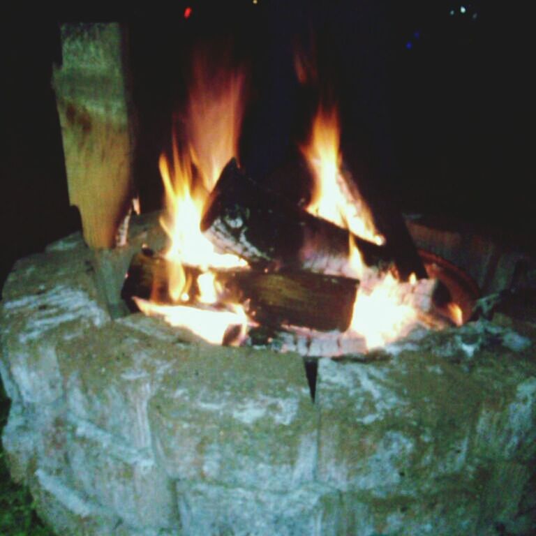 flame, burning, fire - natural phenomenon, heat - temperature, glowing, fire, bonfire, night, orange color, motion, heat, firewood, close-up, outdoors, sunlight, water, no people, high angle view, light - natural phenomenon, illuminated