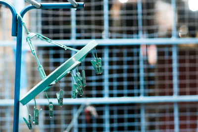 Close-up of metallic railing against window