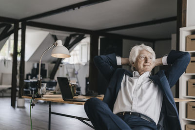 Senior businessman relaxing in his office