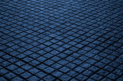 Texture of cobble stone pavement at night time for background