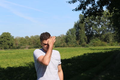 Full length of man standing on field against sky