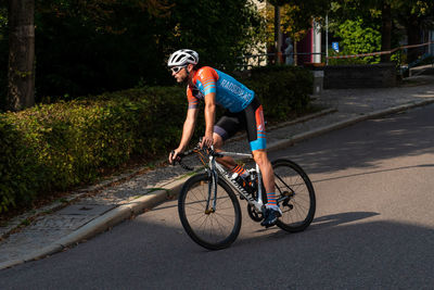 Man riding bicycle on road