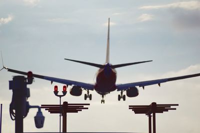 Low angle view of airplane flying against sky