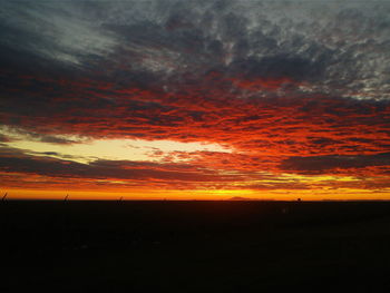 Silhouette of landscape against dramatic sky