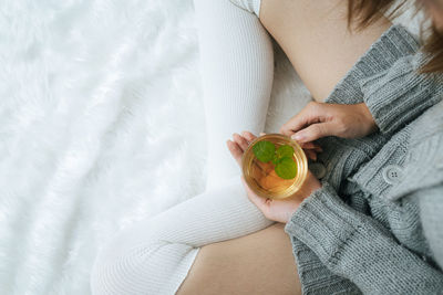 Midsection of woman holding apple