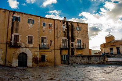 Exterior of old building in city against sky