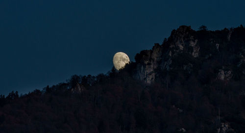 Moon rising behind the mountain