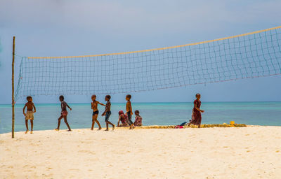 Group of people playing on beach