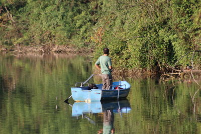 Man on boat sailing in lake