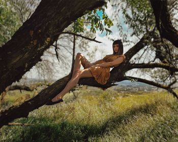 Woman on tree trunk