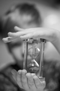 Close-up of girl hand on clock