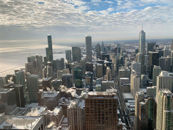 High angle view of modern buildings in city against sky