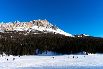 Scenic view of snowcapped mountains against clear blue sky