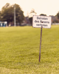 Close-up of information sign on field