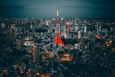 Aerial view of illuminated city buildings against sky