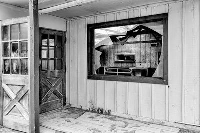 Man hanging on window of abandoned building