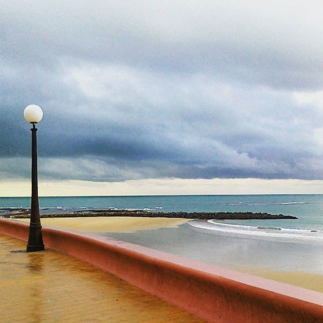 sea, sky, water, horizon over water, scenics, cloud - sky, tranquil scene, tranquility, beauty in nature, beach, nature, cloudy, street light, cloud, idyllic, shore, pier, railing, outdoors, seascape