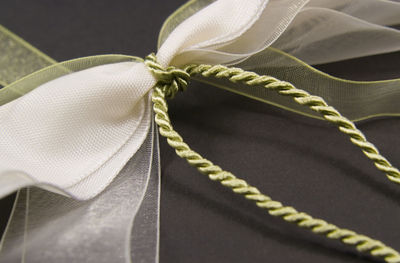 Close-up of rope tied up against black background