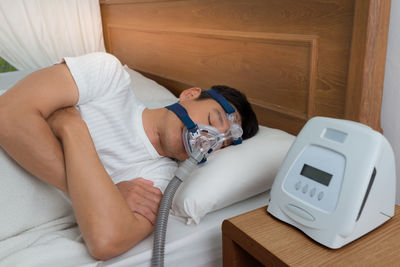 High angle view of woman sleeping on bed at home