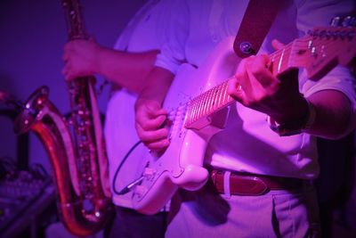 Midsection of men performing on stage