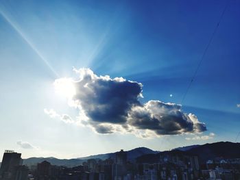 Low angle view of buildings against sky on sunny day