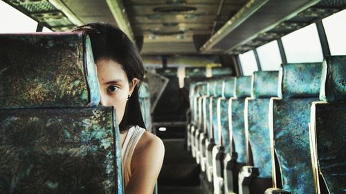 Portrait of young woman in bus