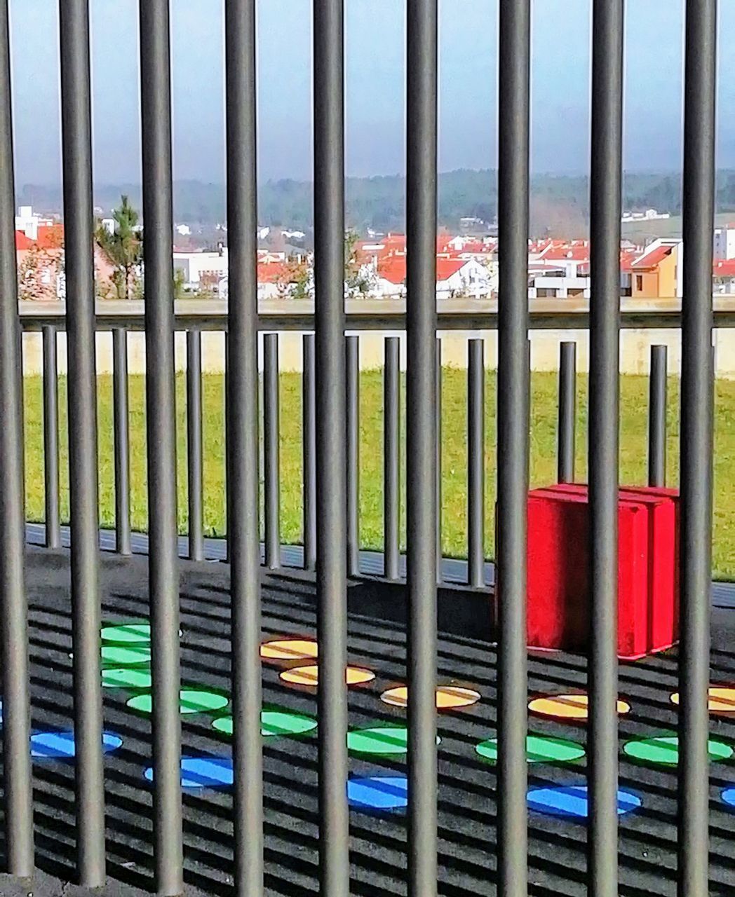 CLOSE-UP OF MULTI COLORED RAILING BY WATER