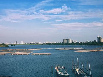 Scenic view of sea by buildings against sky